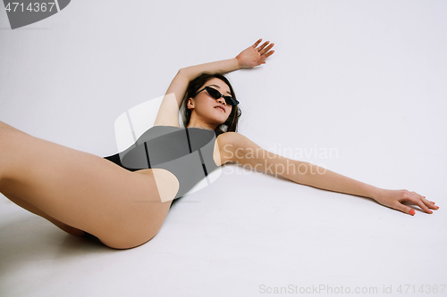 Image of Young female ballet dancer against white studio background