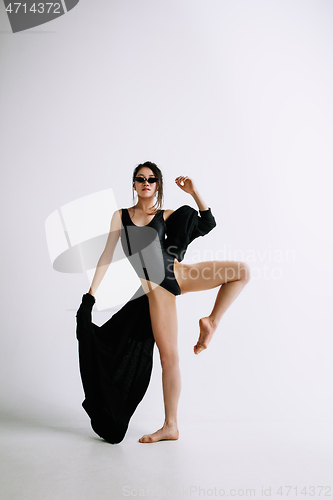 Image of Young female ballet dancer against white studio background