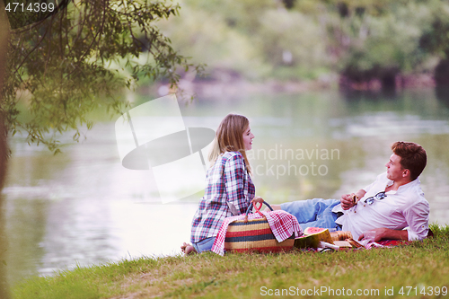 Image of Couple in love enjoying picnic time