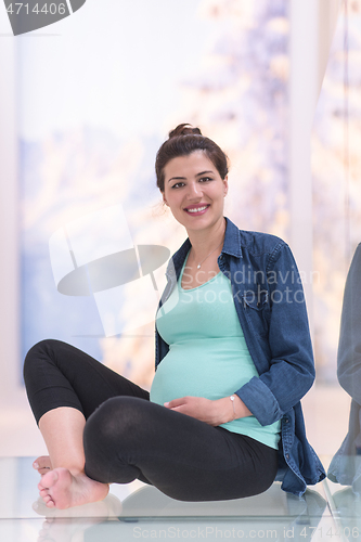 Image of pregnant women sitting on the floor