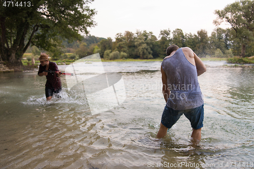 Image of young men having fun with water guns