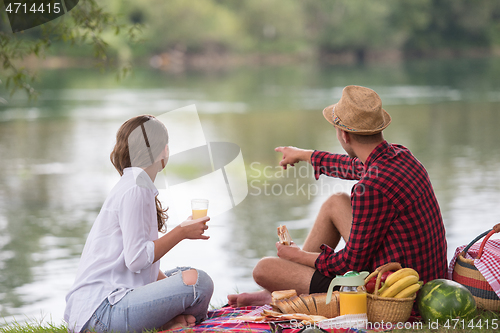 Image of Couple in love enjoying picnic time