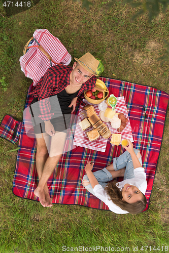 Image of top view of couple enjoying picnic time