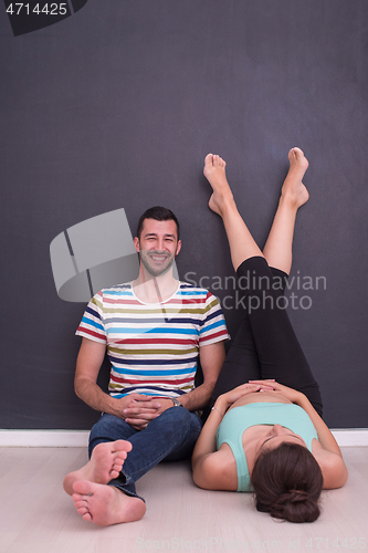 Image of pregnant couple relaxing on the floor