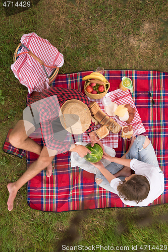 Image of top view of couple enjoying picnic time