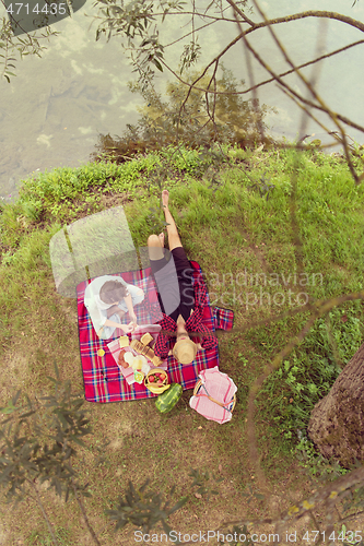 Image of top view of couple enjoying picnic time