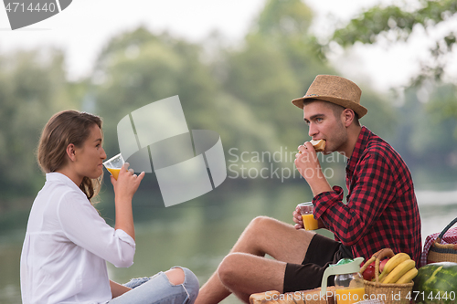 Image of Couple in love enjoying picnic time