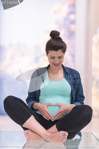 Image of pregnant women sitting on the floor