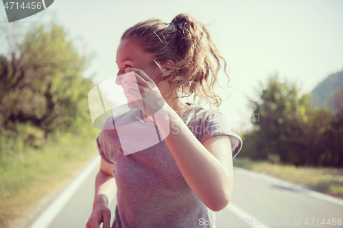 Image of woman jogging along a country road