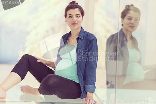 Image of pregnant women sitting on the floor