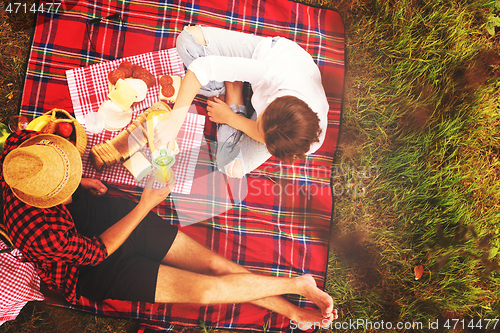 Image of top view of couple enjoying picnic time