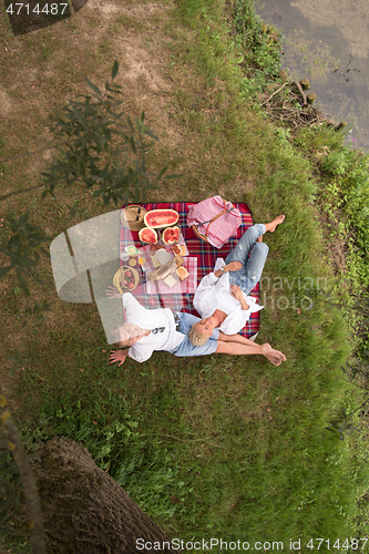 Image of top view of couple enjoying picnic time