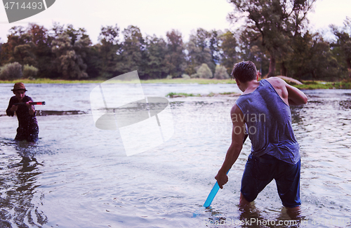 Image of young men having fun with water guns