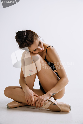 Image of Young female ballet dancer against white studio background