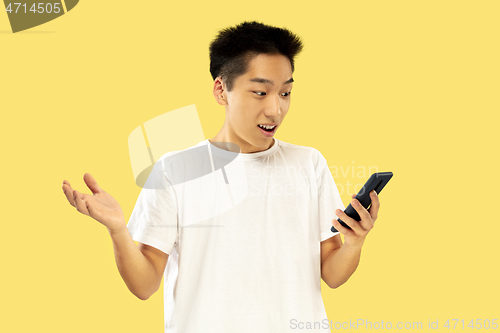 Image of Korean young man\'s half-length portrait on yellow background