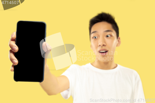 Image of Korean young man\'s half-length portrait on yellow background