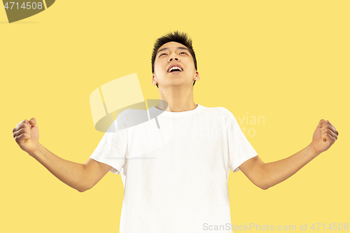 Image of Korean young man\'s half-length portrait on yellow background