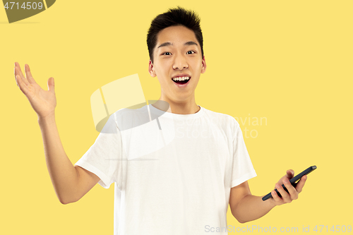 Image of Korean young man\'s half-length portrait on yellow background