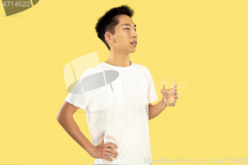 Image of Korean young man\'s half-length portrait on yellow background