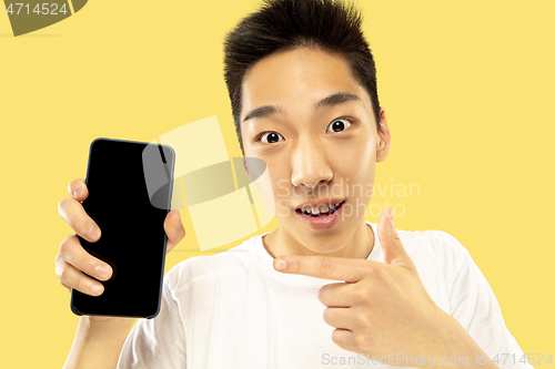Image of Korean young man\'s half-length portrait on yellow background