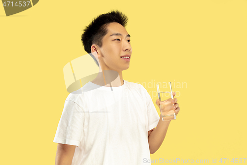 Image of Korean young man\'s half-length portrait on yellow background