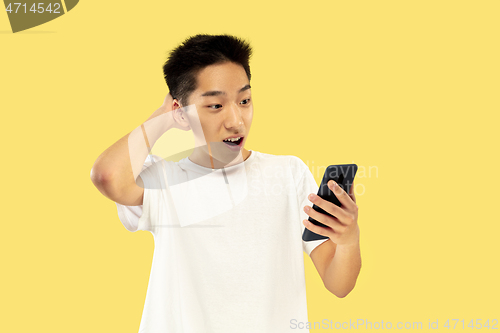 Image of Korean young man\'s half-length portrait on yellow background