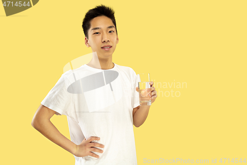 Image of Korean young man\'s half-length portrait on yellow background