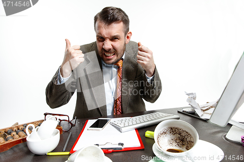 Image of Young man suffering from the talks in the office