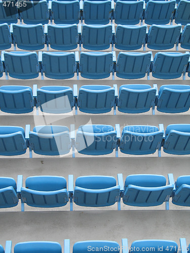 Image of blue aligned plastic chairs