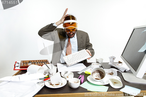 Image of Young man spilled coffee on the keyboard