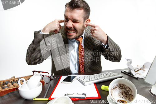 Image of Young man suffering from the talks in the office