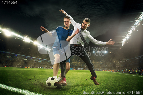 Image of Office man as a soccer or football player at the stadium