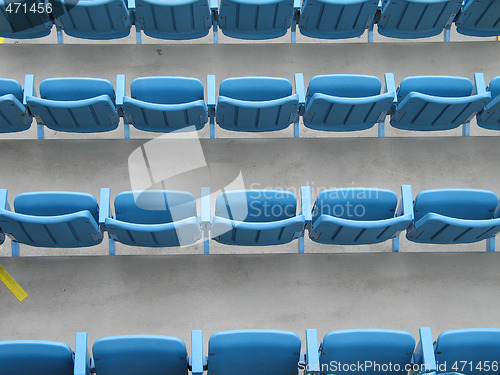 Image of blue aligned plastic chairs
