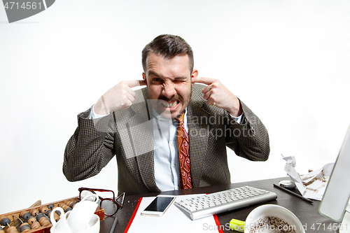 Image of Young man suffering from the talks in the office