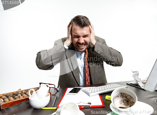 Image of Young man suffering from the talks in the office