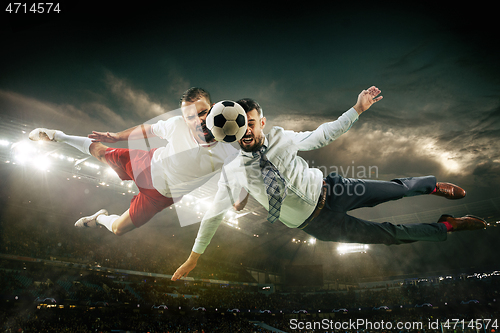 Image of Office man as a soccer or football player at the stadium