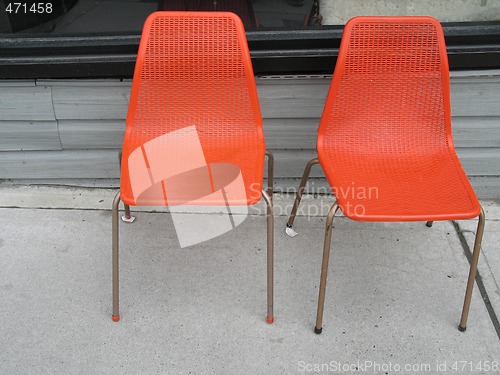 Image of two old orange chairs