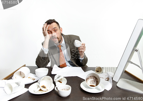 Image of Young man drinking a lot of coffee