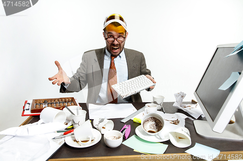 Image of Young man spilled coffee on the keyboard