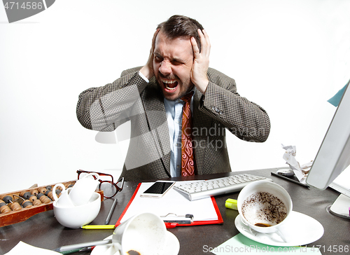 Image of Young man suffering from the talks in the office