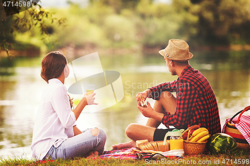 Image of Couple in love enjoying picnic time
