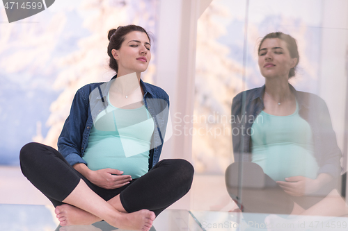 Image of pregnant women sitting on the floor