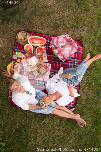 Image of top view of couple enjoying picnic time