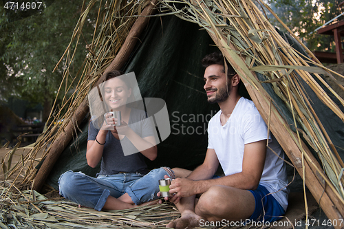 Image of couple spending time together in straw tent