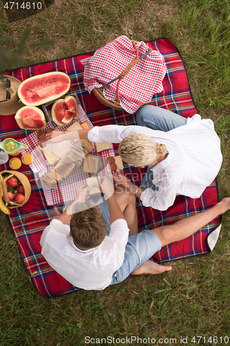 Image of top view of couple enjoying picnic time