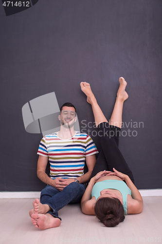 Image of pregnant couple relaxing on the floor