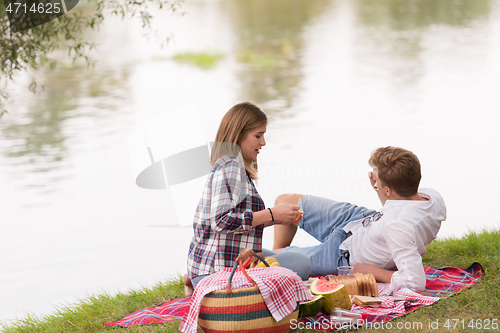 Image of Couple in love enjoying picnic time