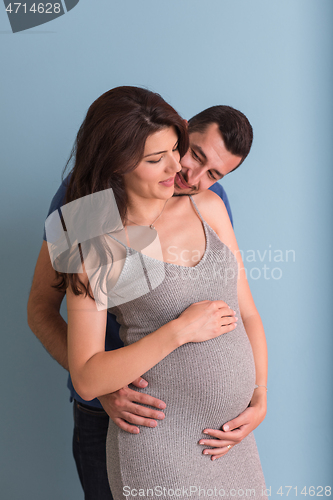 Image of pregnant couple  isolated over blue background