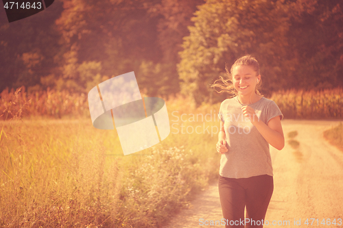 Image of woman jogging along a country road