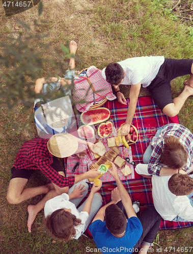 Image of top view of group friends enjoying picnic time